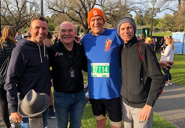Keegan Crage and an On My Feet participant with Rob de Castella and Steve Moneghetti before the Melbourne Marathon